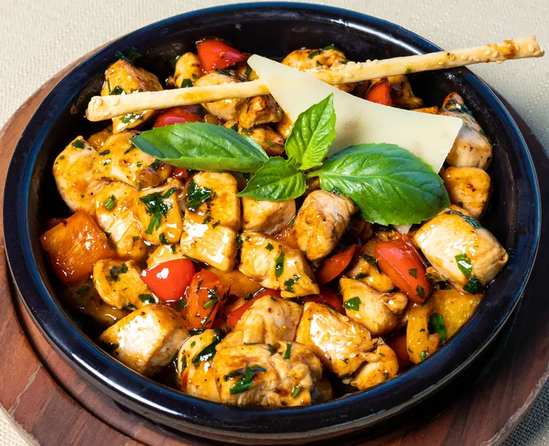 Peppered chicken simmering in a pot
